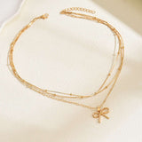 Elegant Gold Bow Pendant Necklace with Layered Chains image 0
