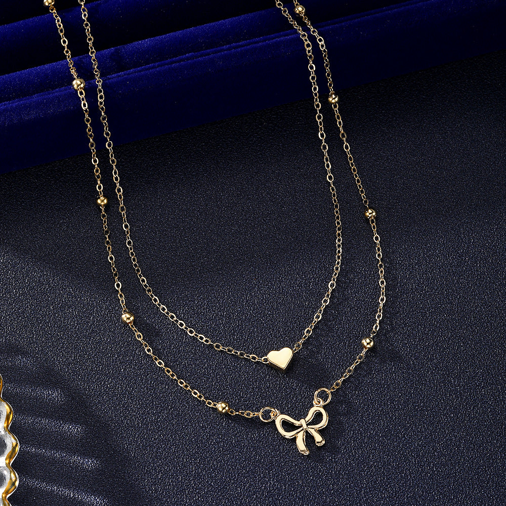 Layered Gold Heart & Bow Pendant Necklace